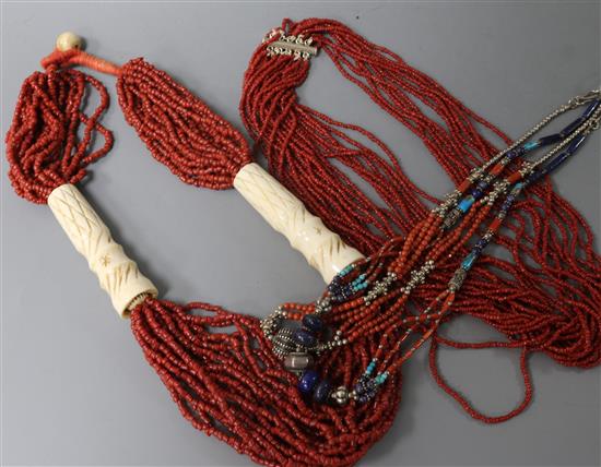 An Indian bone and multi-strand coral bead necklace and three other necklaces,